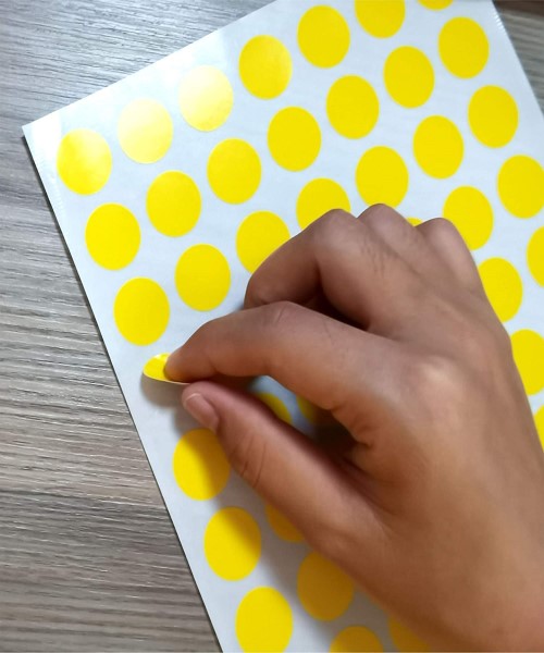 Yellow colored circular adhesive stickers