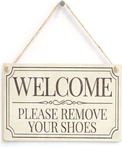 Wooden welcome sign hanging at home entrance