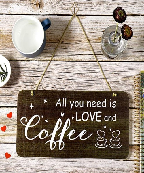 A hanging sign for coffee lovers. All you want is love and coffee written on a hanging wooden block