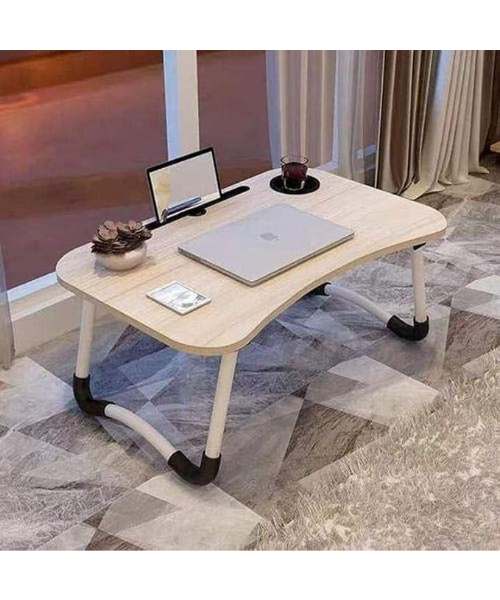 A portable laptop table with foldable legs a slot for holding a tablet and notebook and a slot for a cup