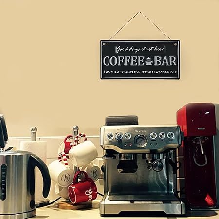 A wooden sign hanging for the coffee corner, printed with the phrase (Coffee Bar Good Days Start Here)