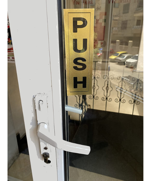 A guide sign , a golden adhesive sticker for the glass door